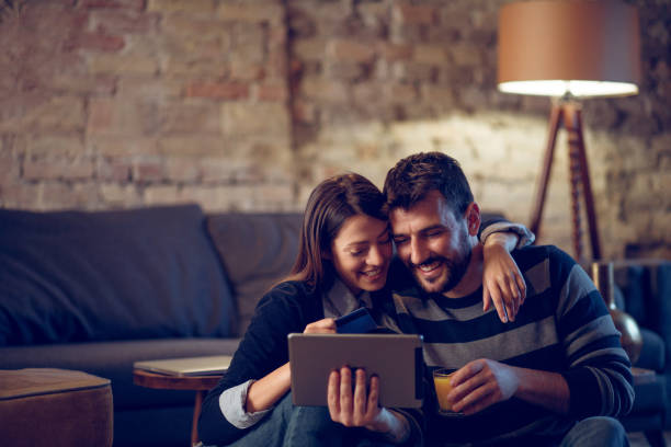 istock Young couple shopping online using digital tablet 936406772