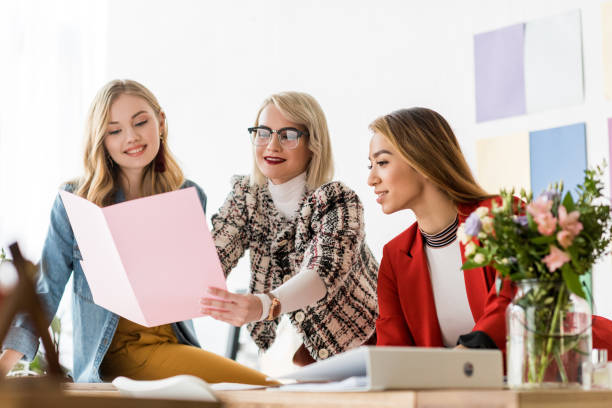 istock fashionable magazine editors working with documents in modern office 936407976