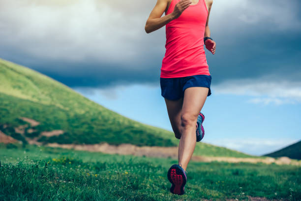 istock fitness woman trail runner running in mountains 936407984