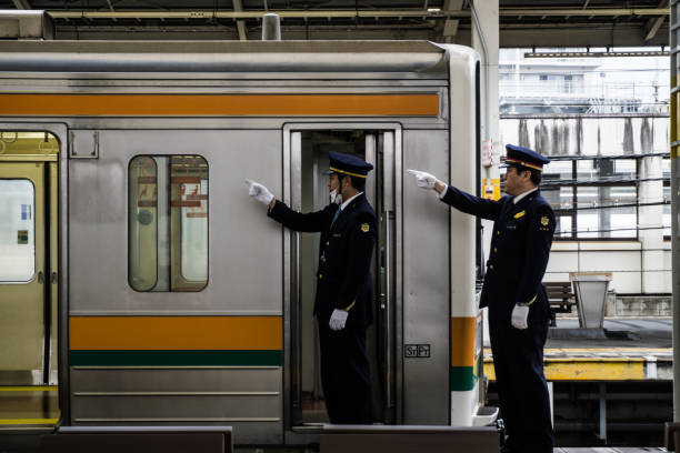 Japanese train driver conduct safety checks before departure Shizuoka, Japan - March 10th, 2018: Japanese train driver conduct safety checks before departure transport conductor stock pictures, royalty-free photos & images