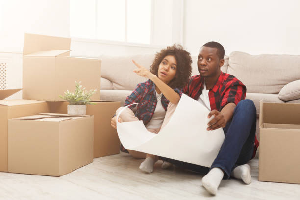istock Young balck couple unpacking moving boxes 936410296