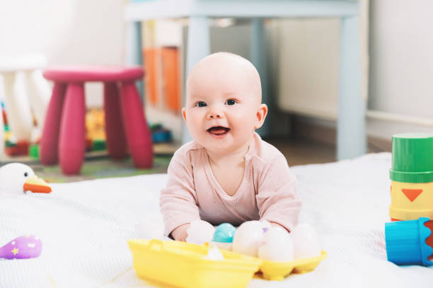 istock Smiling cutest baby playing with colorful toys. 936410916