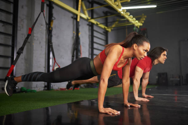 istock Man and woman working out in gym 936412072