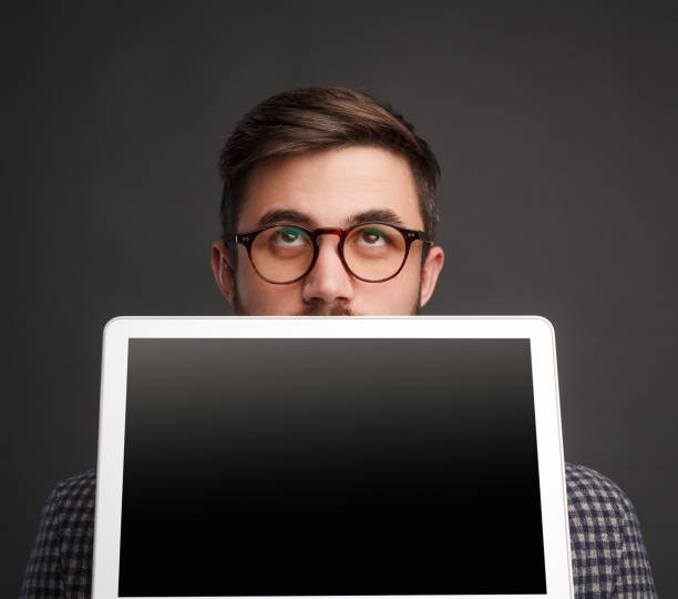 istock Pensive man showing laptop 936415878