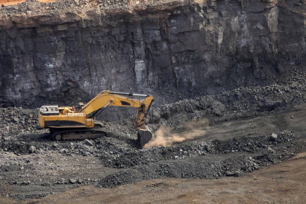 istock Excavator digging and loading ore rich rocks in a Manganese open pit mine 936417944