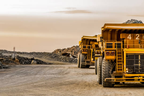 large mining rock dump trucks transporting platinum ore for processing - mining imagens e fotografias de stock