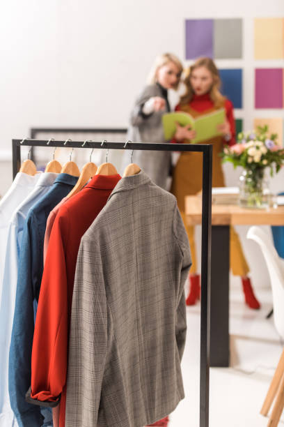 istock stylish dressmakers working in modern office with clothes on foreground 936419938