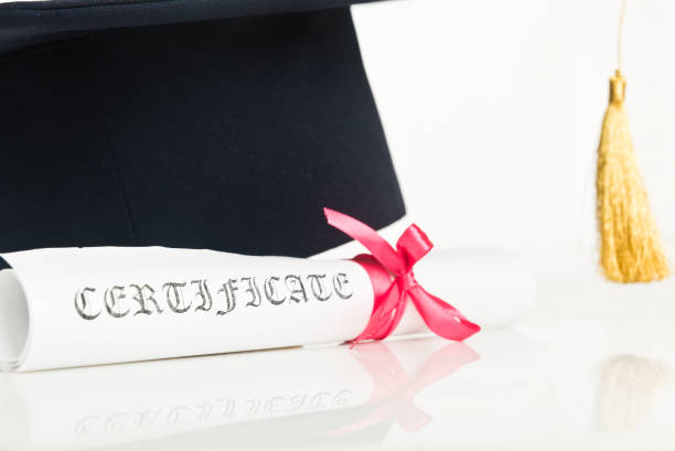 istock Graduation Cap with Degree Isolated on White Background 936424032