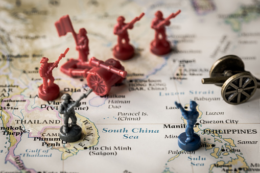 Illustrative Editorial image using plastic toy soldiers and canons on a map of the South China Sea. Tensions and conflict in the region have been heating up in recent years. Trade wars will only make it worse.