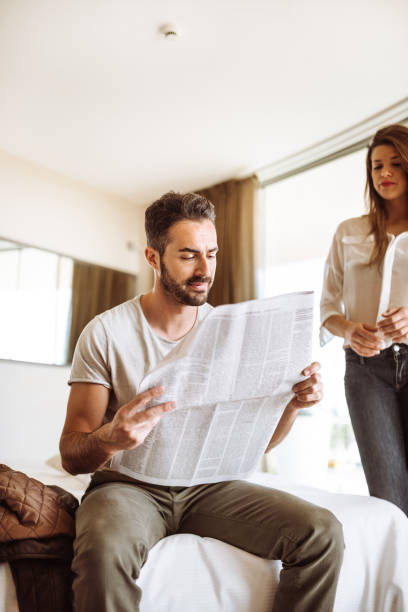 istock couple reading the newspaper on the hotel 936424888