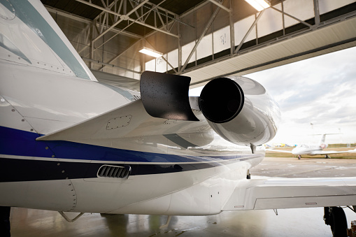 Private jet aircraft in the hangar open for regular maintenance service.