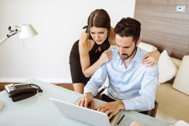 istock couple of colleagues at the pc working together 936426192