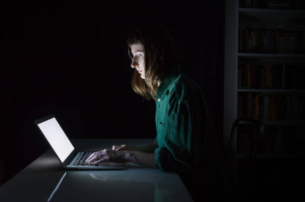 istock Woman works at laptop computer late in the evening 936426554