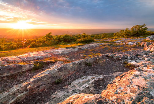 Sun sets over rocky granite outcroppings in early summer at top of New Jersey, High Point State Park, on the Appalachian Trail
