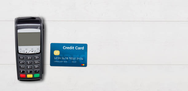 istock Payment terminal and credit card on wooden background 936427546