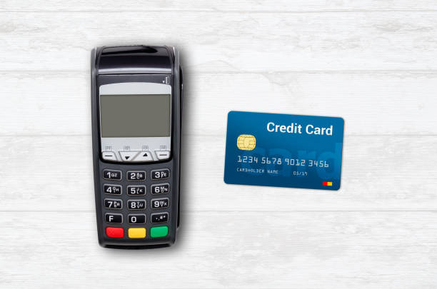istock Payment terminal and credit card on wooden background 936427566