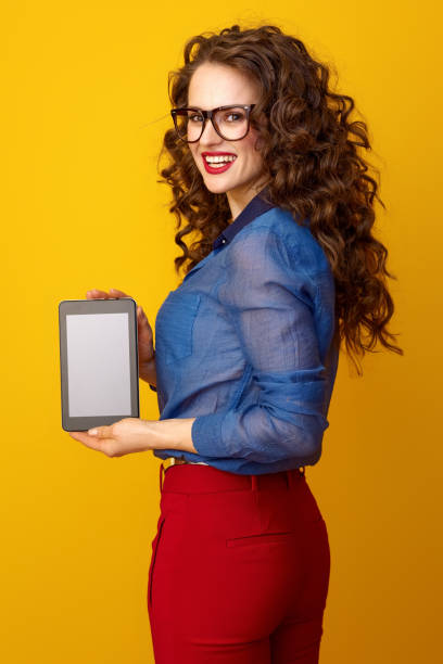 istock happy young woman showing tablet PC blank screen 936428736