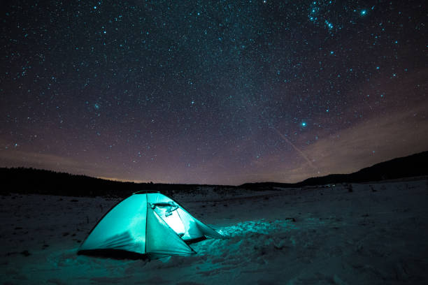 istock Night mountain landscape with illuminated tent 936429180