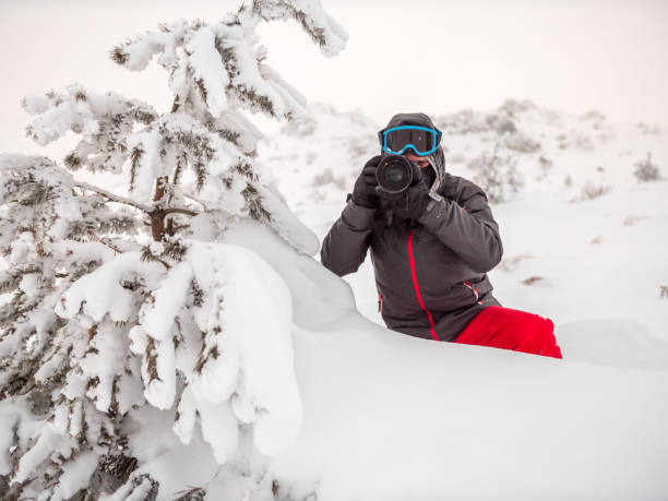 istock Photographer photographing outdoors in the snowy mountain 936429332