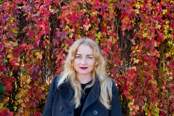 istock Beautiful blond near fence from leaves 936430730