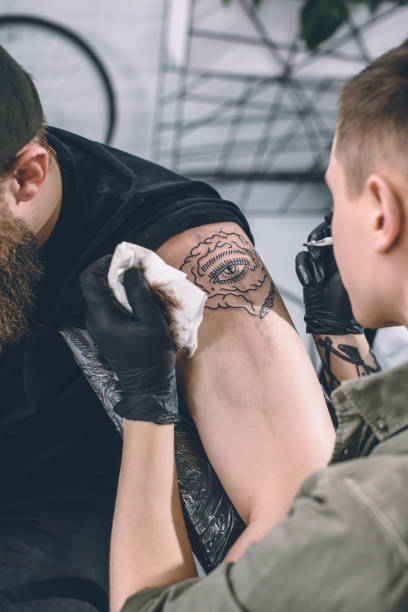 istock Tattoo artist working on shoulder piece in studio 936432188