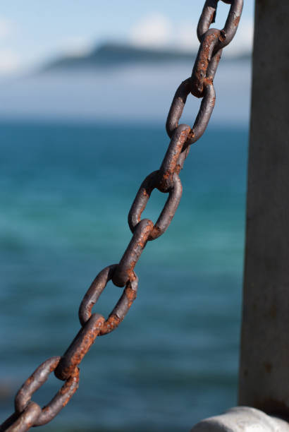 istock Rusty metal chain against the blue gulf 936432346
