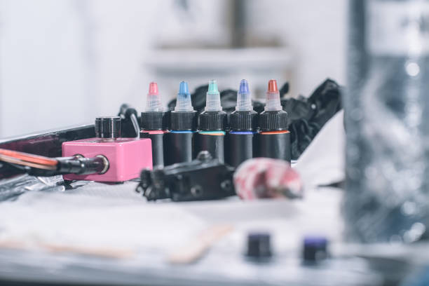 istock Tattoo machine and bottles with colorful ink 936432670