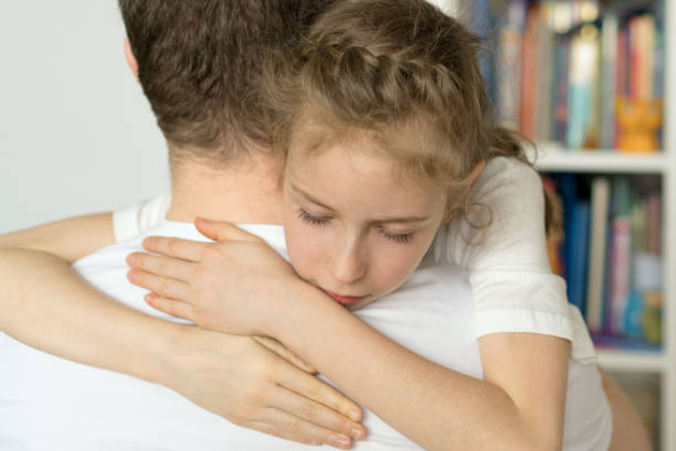 istock Sad little girl hugging her dad. 936433600