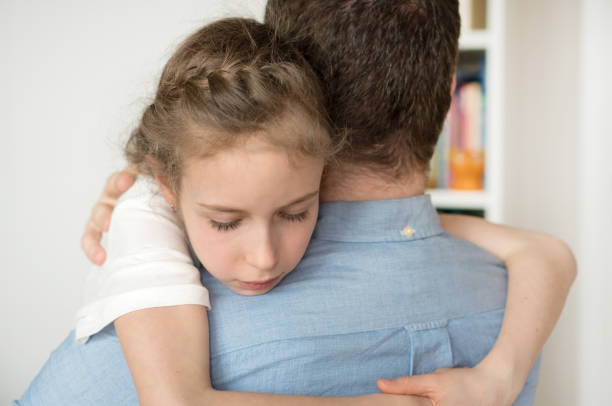 istock Sad little girl hugging her dad. 936433652