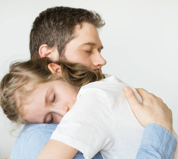 istock Sad little girl hugging her dad. 936433656