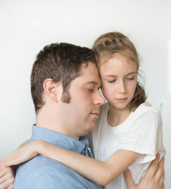 istock Sad little girl hugging her dad. 936433664