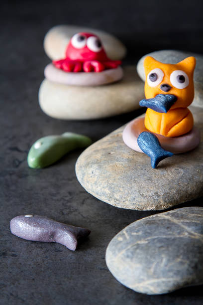 istock Animals from mastic Cat, fish and crab. Decor cake. Dark background. 936434230