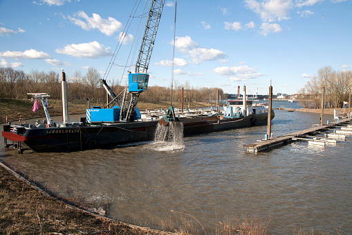 The marina of Cologne / Porz will be cleaned by a dredger now-a-days.