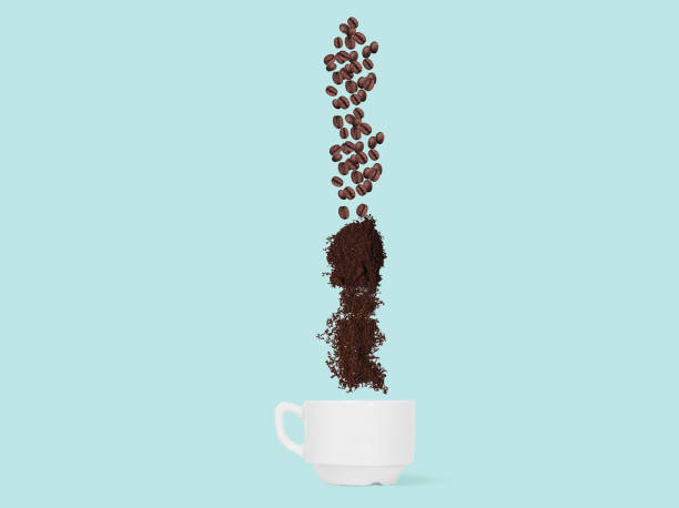 istock Coffee beans and ground coffee fall into the cup. ConceptCoffee beans and ground coffee fall into the cup. 936435700