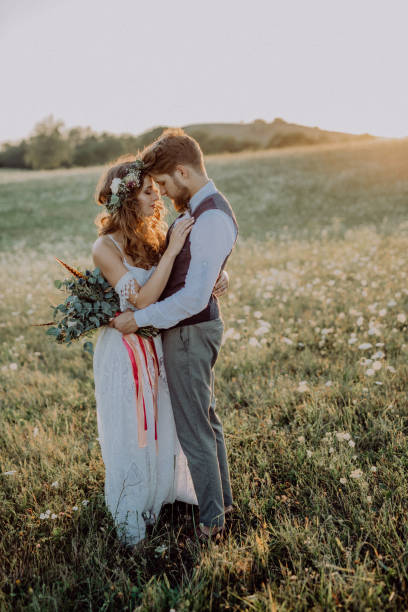 istock Beautiful bride and groom in green nature, hugging. 936436320