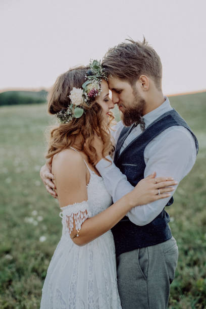 istock Beautiful bride and groom in green nature, hugging. 936436512