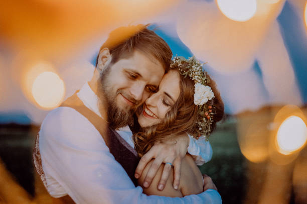 istock Beautiful bride and groom on a meadow at night. 936436700