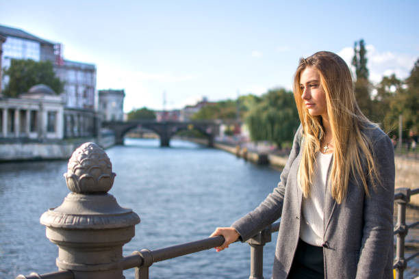 istock Young woman enjoying the view at river Spree in Berlin. 936437246