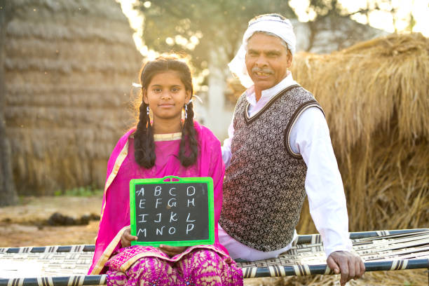 Father with daughter holding slate Portrait of farmer with daughter holding slate bed of hay stock pictures, royalty-free photos & images