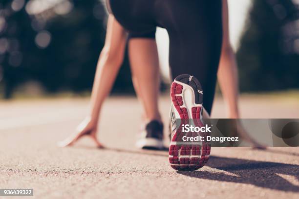 Ready To Go Close Up Cropped Low Angle Photo Of Shoe Of Female Athlete On The Starting Line Of A Stadium Track Preparing For A Run Sunny Spring Day Stock Photo - Download Image Now