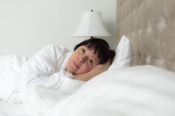 istock brunette woman in bed 936442020