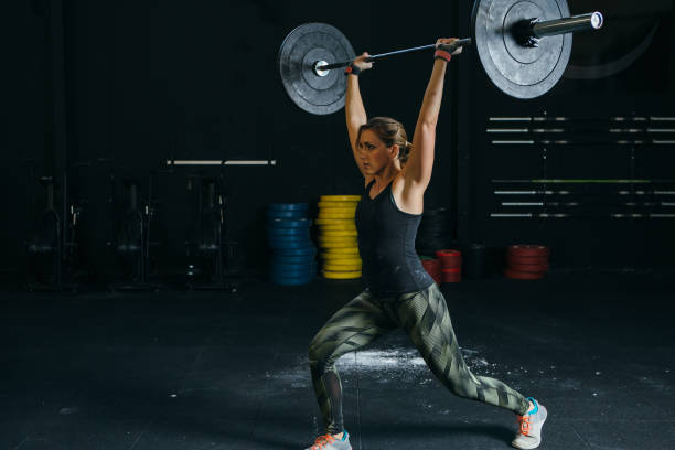 istock Girl does jerk with barbell 936442432