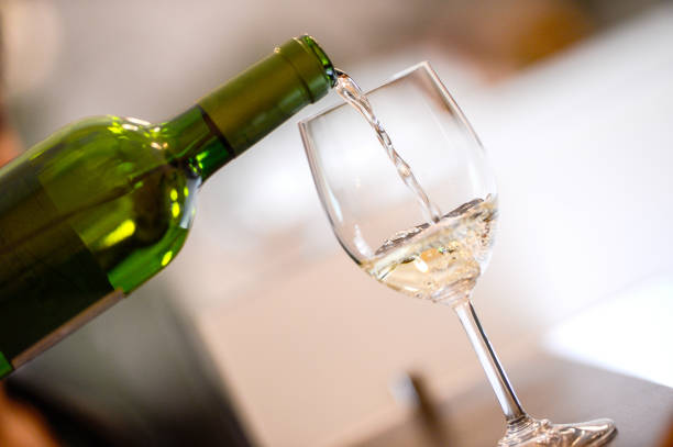 istock Tasting-White wine pour in a glass 936443036