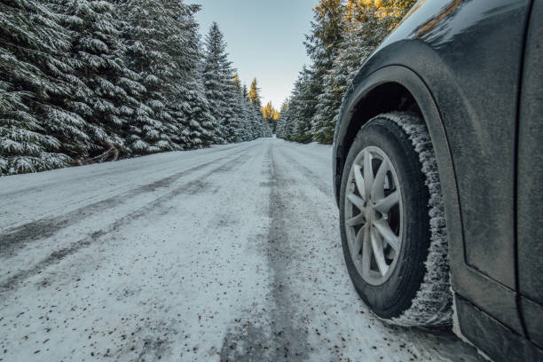 istock Car tire on winter road 936443866