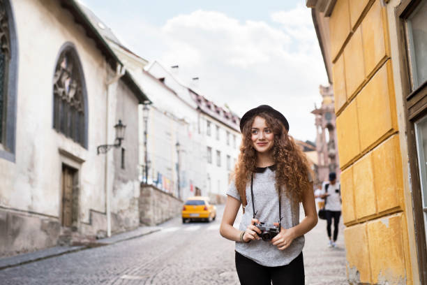 istock Beautiful young tourist with camera in the old town. 936445616
