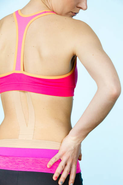 istock Woman with medical kinesio taping on back 936447678