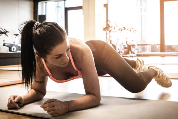 istock Young woman exercise abdominal muscle. 936447726
