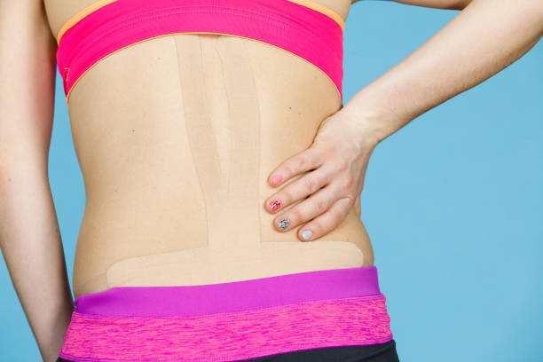 istock Woman with medical kinesio taping on back 936447842