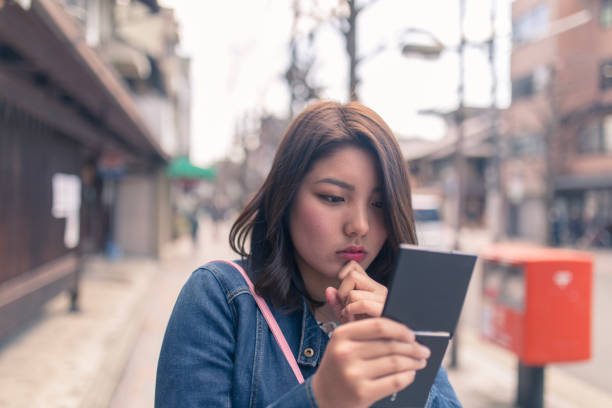 istock Young woman making up on street 936456404