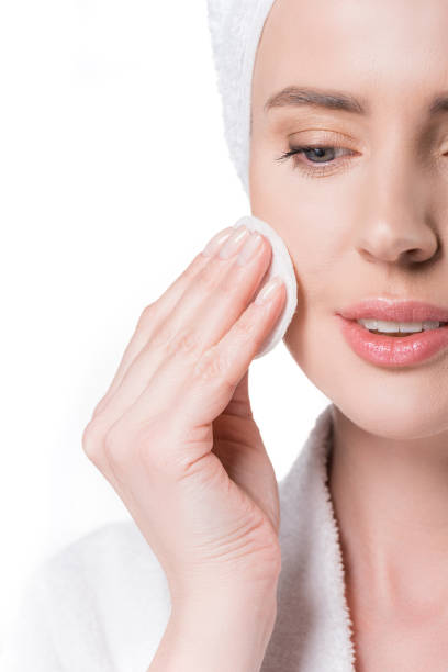 istock Cropped view of woman using cotton pad isolated on white 936459618